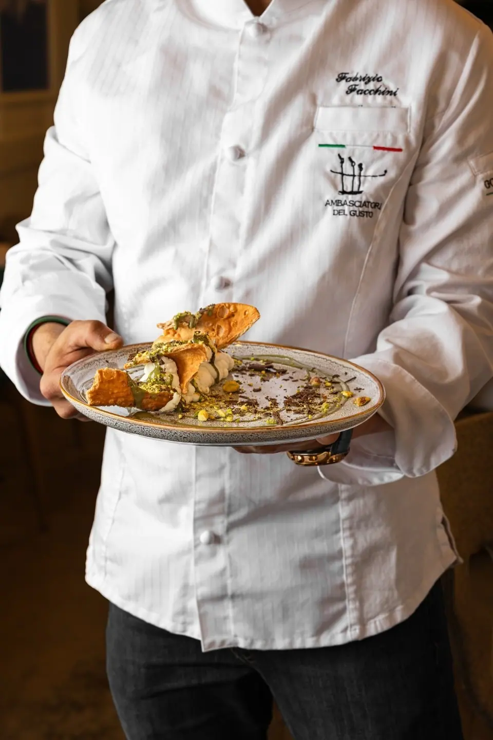 Chef Fabrizio Facchini carrying a plate