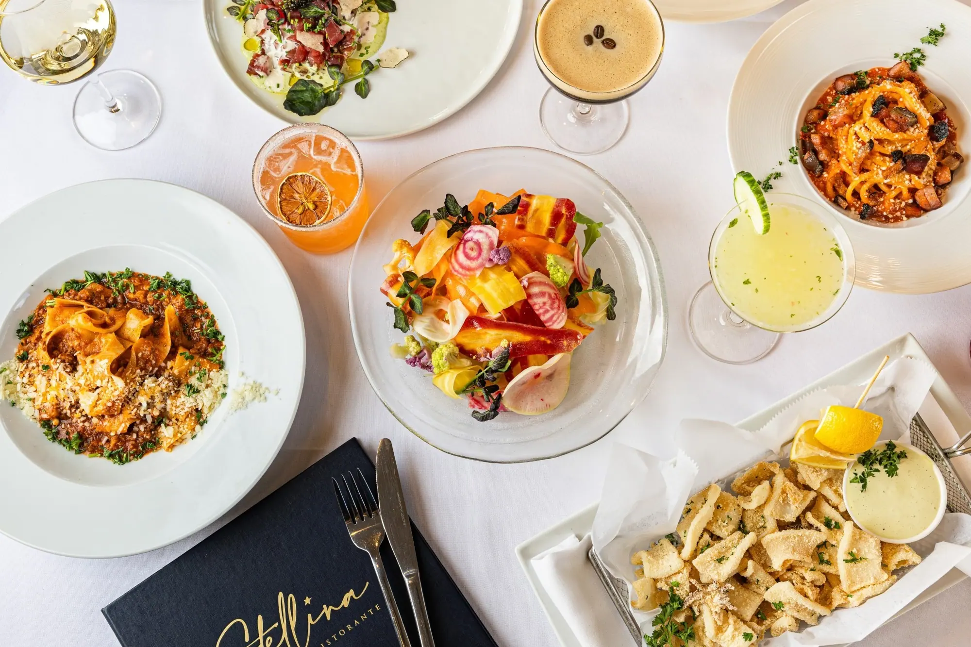 An overhead spread of brunch plates and fresh juices at Stellina